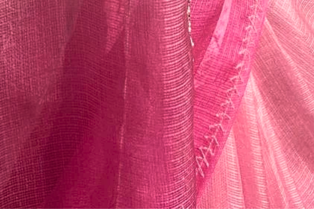 Close-up of authentic pink Kota Doria fabric showcasing its lightweight texture and distinctive handwoven square weave from Rajasthan.